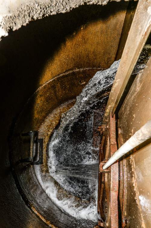 Francisco Kjolseth  |  The Salt Lake Tribune
The elevation of Parleys Creek is seen at the bottom of a  pipe at the main hub in Sugar House that is controlled twice a day in order to deliver water once a week in the summer for shareholders who have water rights.