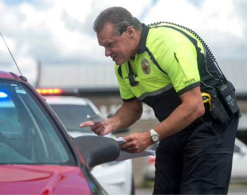 Rick Egan  |  The Salt Lake Tribune

West Valley police officer Kim Albrecht talks to a driver, that was pulled over for not wearing a seat belt, on Redwood Road in West Valley City, Thursday, May 28, 2015.