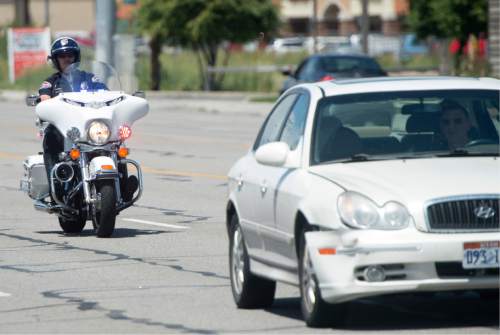 Rick Egan  |  The Salt Lake Tribune
A West Valley police officer pulls over a driver on Thursday that was spotted as not wearing a seat belt, on Redwood Road in West Valley City.