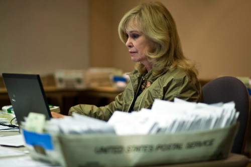 Chris Detrick  |  Tribune file photo
Salt Lake County Clerk Sherrie Swensen verifies some of the thousands of provisional and mail-in ballots during a previous election cycle. Fourteen of 16 Salt Lake County cities are using vote-by-mail this year.