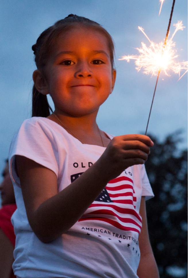 Rick Egan  |  The Salt Lake Tribune

Kacie Kiker, 11, Layton, plays with a sparkler before the Sugarhouse fireworks, Saturday, July 4, 2015.