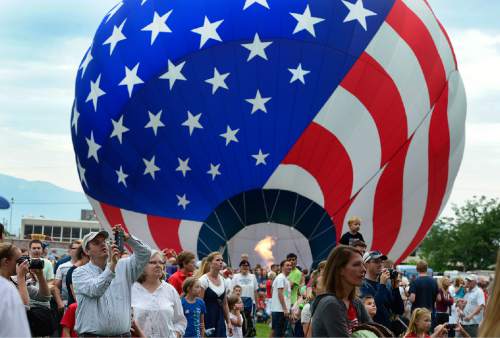 Scott Sommerdorf   |  The Salt Lake Tribune
Balloons are filled with heated air as they "stand up" after the decision was made not to launch due to changeable weather at the Provo Balloon Fest, Saturday, July 4, 2015.