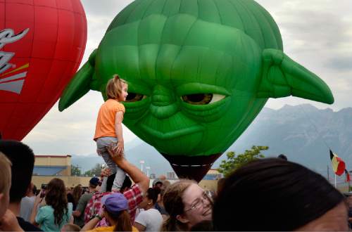 Scott Sommerdorf   |  The Salt Lake Tribune
"A small child you are ..." the actual Yoda might say.  Balloons are filled with heated air as they "stand up" after the decision was made not to launch due to changeable weather at the Provo Balloon Fest, Saturday, July 4, 2015.