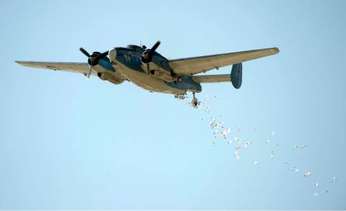 Rick Egan  |  The Salt Lake Tribune

Former Air Force Col Gal Halvorsen, drops 1000 candy bars from a fixed wing bomber from World War II over Scera Park, in Orem, Friday, July 3, 2015.