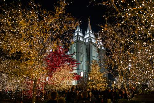 Chris Detrick  |  The Salt Lake Tribune
Visitors look at the Christmas lights on Temple Square Friday November 29, 2013.  The first year the light were put up on Temple Square was in 1965. The lights will run through the end of the year.