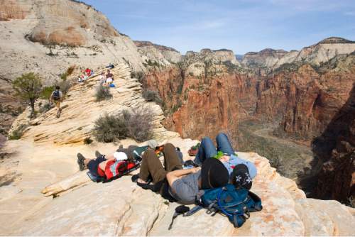 Zion National Park will turn 100 year old  this Summer.  Zion was established as Makuntaweap National Monument on July 31, 1909 by President William Taft.   Hikers take a well deserved rest at the top of  Angel's Landing Trail.   It's one of the premier hikes in the park which takes the hiker up  a steep rock spine that climbs to a magnificent view of the Virgin River and Zion Canyon below.  The hikes is not for those with fear of heights.  An anchor chain is embedded in the rock in steep places along the trail that hikers can grab onto for safety.   Al Hartmann/The Salt Lake Tribune     3/25/2009