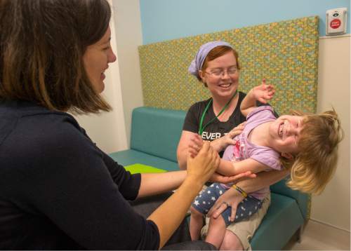 Rick Egan  |  The Salt Lake Tribune
Emily Ross holds her 2-year-old daughter Ella, as neurologist Dr. Betsy Osrtander checks her out, during a special clinic for children with chromosomal disorders at Primary Children's Hospital on Friday. Trisomy is the presence of an extra chromosome.