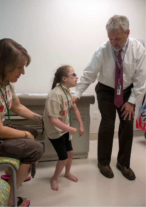 Rick Egan  |  The Salt Lake Tribune

Susan Aragona, Andover, Nj, (left) assists as Dr. Alan Stotts, orthopedic specialist, checks out her 10-year-old daughter, Aniella Aragona, during a special clinic for children with chromosomal disorders at Primary Children's Hospital, Friday, July 10, 2015. Trisomy is the presence of an extra chromosome.