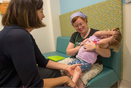 Rick Egan  |  The Salt Lake Tribune

Emily Ross holds her 2-year-old daughter Ella, as Dr. Betsy Osrtander, Neurology, checks her out, during a special clinic for children with chromosomal disorders at Primary Children's Hospital, Friday, July 10, 2015. Trisomy is the presence of an extra chromosome.