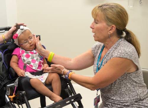 Rick Egan  |  The Salt Lake Tribune

Nutrition specialist Helene Taylor (right) visits with19-month-old, Payton Thompson, during a special clinic for children with chromosomal disorders at Primary Children's Hospital, Friday, July 10, 2015. Trisomy is the presence of an extra chromosome.