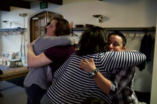 Jim McAuley | The Salt Lake Tribune
Panel experts Rachel Heller, left, and Alex Florence, right, hug participants after the Transgender 101 workshop at the 22nd Circling the Wagons conference, a conference designed to build understanding between LGBT Mormons and members of the LDS Church, at Wasatch Presbyterian Church in Salt Lake City on Saturday, February 22, 2014.