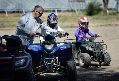Scott Sommerdorf   |  The Salt Lake Tribune
Dale Bartholomew leads children through a drill during ATV training on Saturday. Primary Children's Hospital teamed up with Safe Kids and the Weber-Morgan Health Department to offer a special one-day course designed to keep kids safe while riding ATVs.