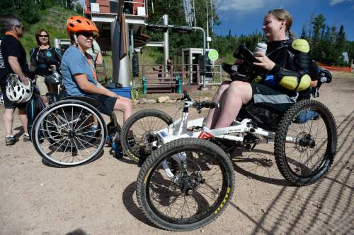 Francisco Kjolseth | The Salt Lake Tribune
Sylvie Fadrhonc, left, meets Stephanie Boyles as they get ready to participate in the Downhill 4-Cross Mountain Biking clinic at the Canyon's resort on Friday, July 10, 2015. The No Barriers Summit sponsored by the National Ability Center drew hundreds of athletes and artists to participated in a number of different clinics.