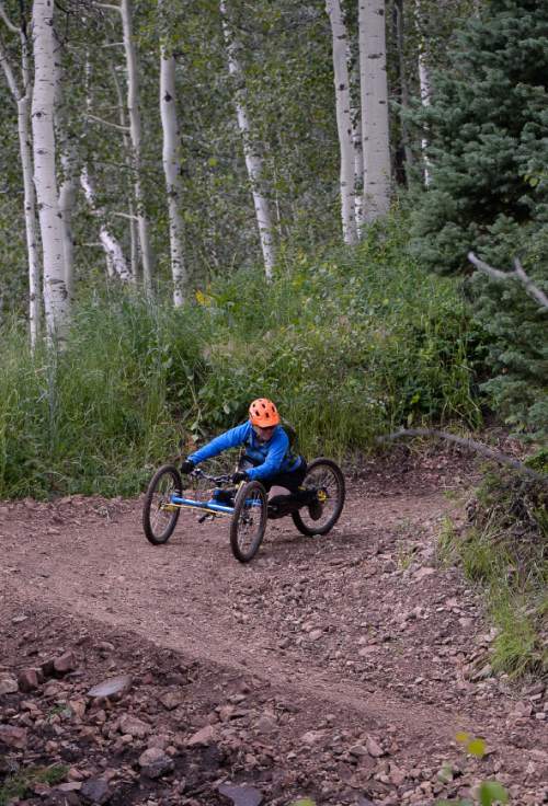 Francisco Kjolseth | The Salt Lake Tribune
Sylvie Fadrhonc, who lost mobility of her legs in a car accident 7-years ago rounds a corner on her special hand cycle as she acts as a volunteer for the Downhill 4-Cross Mountain Biking clinic at the Canyon's resort on Friday, July 10, 2015. The No Barriers Summit sponsored by the National Ability Center drew hundreds of athletes and artists to participated in a number of different clinics.