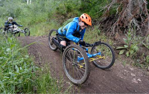 Francisco Kjolseth | The Salt Lake Tribune
Sylvie Fadrhonc, who lost mobility of her legs in a car accident 7-years ago, cruises down the mountain on her custom hand cycle bike while volunteering for the Downhill 4-Cross Mountain Biking clinic at the Canyon's resort on Friday. The No Barriers Summit sponsored by the National Ability Center drew hundreds of athletes and artists to participated in a number of different clinics.