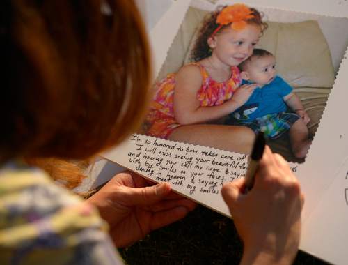 Leah Hogsten  |  The Salt Lake Tribune
Amy Chaney writes below a photo of Tylee and Blake as she writes the two children a note, telling them she'll miss seeing them everyday and taking care of them at Busy Bee Playhouse.  Friends of Russell and Shawna Smith hold a candlelight vigil for their friends, Tuesday, June 23, 2015, on the Smith's lawn. On Father's Day, police found the couple and their two children, Tylee, 6 and Blake, 2, dead inside their house. Police believe Russell Smith killed his wife and children and then himself.