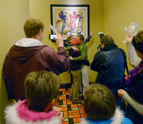 Steve Griffin  |  The Salt Lake Tribune


Rev. Monica Hall, of Trinity Presbyterian Church in Ogden, holds up her hands up as she announces Mark Marinan and Jeff poor officially married at the Hampton Inn Suites in Ogden, Utah Monday, December 23, 2013 Volunteer clergy were performing marriage ceremonies for couples across the street from the Weber County Clerk's Office in downtown Ogden.
