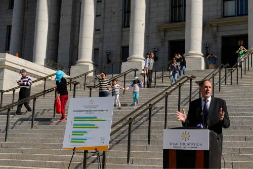 Trent Nelson  |  The Salt Lake Tribune
A group of tourists pass by while Dan Bammes speaks as the Utah Foundation releases the final segment of a four-part series on the differences between the view of different generations in Utah, focusing on millennials, at a press conference at the State Capitol Building in Salt Lake City, Tuesday July 14, 2015.