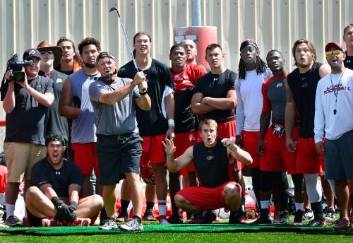 Scott Sommerdorf   |  The Salt Lake Tribune
Utah head coach Kyle Whittingham follows through on a golf shot as players react to it heading towards a group of spectators. The team held some sort of golf competition after Utah football practice with pads on the baseball field, Thursday, August 7, 2014.