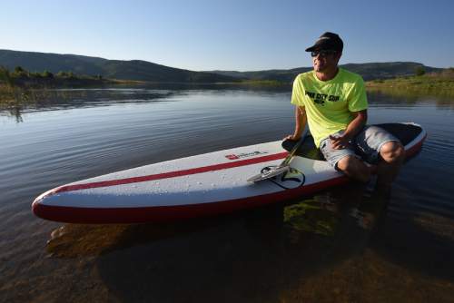 Francisco Kjolseth | The Salt Lake Tribune
Trent Hickman of Park City grew up with a love for water sports that developed from both living next to the Provo river and visits to Malibu where his mother grew up. Later in life he divided his time between Utah for the skiing and Costa Rica to surf. It was then that his introduction to stand up paddle boarding known as SUP, sparked a new passion that he could do on the lakes and rivers of Utah.