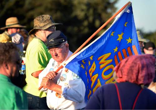 Scott Sommerdorf   |  The Salt Lake Tribune
Jerry Anderson carries a Mormon Battalion flag as he begins walking in the five-mile commemorative Encampment Hike Saturday, July 18, 2015. The hike, which follows Emigration Creek through Salt Lake City, began at Donner Park and ended at First Encampment Park, near the site where the Mormon pioneers camped in the Salt Lake Valley on July 22, 1847.