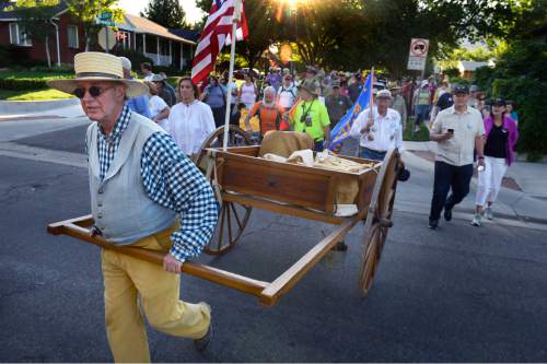 Scott Sommerdorf   |  The Salt Lake Tribune
Mike Neilson leads a group of hikers pushing his hand-made hand cart as families walk in the five-mile commemorative Encampment Hike Saturday, July 18, 2015. The hike, which follows Emigration Creek through Salt Lake City, began at Donner Park and ended at First Encampment Park, near the site where the Mormon pioneers camped in the Salt Lake Valley on July 22, 1847.