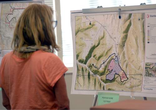 Al Hartmann |  The Salt Lake Tribune
A person looks at a map with proposed tar sands mine footprint on the Uintah- Grand County line at a crucial hearing at the Utah Division of Oil, Gas and Mining Tuesday, June 30 at the Utah Department of Natural Resources building in Salt Lake City.