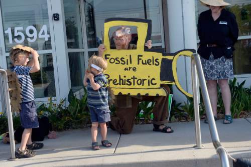 Al Hartmann |  The Salt Lake Tribune
Paul Wickelson and his sons Otis, 6, and Lev, 3, performed a skit on the steps of the Utah Department of Natural Resources before a crucial hearing Tuesday, June 30 at the Utah Division of Oil, Gas and Mining in Salt Lake City.