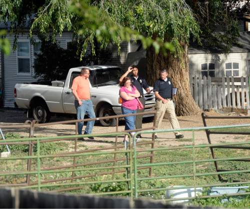 Al Hartmann  |  The Salt Lake Tribune
West Valley City police interview neighbors near a backyard horse pasture at 5200 W. and 3600 S. in West Valley City where the body of a 12-year-old girl was found Friday July 17.