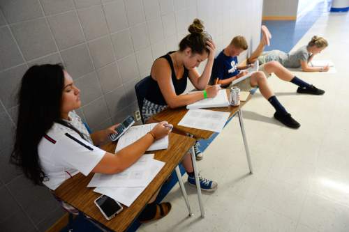 Francisco Kjolseth | The Salt Lake Tribune  
Sofia Chico, 15, left, and Megan Gurr, 16, work on a complex numbers assignment at Bingham High as students earn high school credits during the summer months to get a head-start on graduation requirements or to make up for failed classes. On Tuesday, June 30, a group managed to carry on despite the AC going out a few days prior as they waited for the system to be fixed.