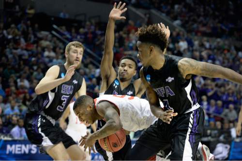 Scott Sommerdorf   |  The Salt Lake Tribune
Utah guard Delon Wright (55) attracted a lot of attention under the basket during second half play. Utah defeated Stephen F. Austin 57-50 at the Moda Center in Portland, Thursday, March 19, 2015.