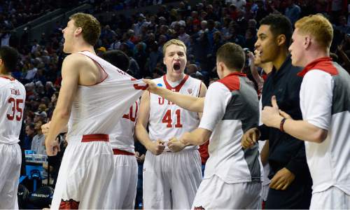 Scott Sommerdorf   |  The Salt Lake Tribune
Utah players, including Utah forward Jeremy Olsen (41), center, celebrate as the team pulled away in the closing seconds to seal the win. after the Utes won their first NCAA tournament game in ten years.  Utah defeated Stephen F. Austin 57-50 at the Moda Center in Portland, Thursday, March 19, 2015.