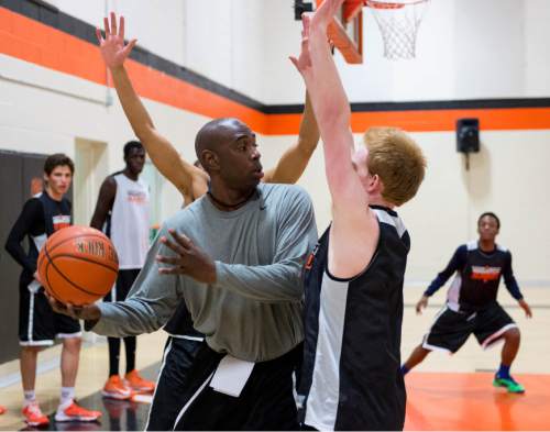 Trent Nelson  |  The Salt Lake Tribune
Wasatch Academy basketball coach Geno Morgan runs a defense drill during practice in Mt. Pleasant, Tuesday February 25, 2014.