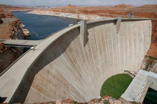 Paul Fraughton  |  Tribune file photo
Lake Powell stretches out behind the Glen Canyon Dam. Officials propose raising fees for using recreational facilisies around the dam.