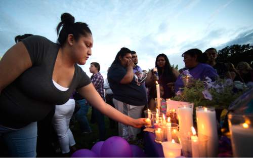 Rick Egan  |  The Salt Lake Tribune

Mercedes Charley lays a candle in remembrance of Kailey Vijil, as friends and family gathered for a candle light vigil, in memory of the 12-year-old West Valley City girl who died earlier this week, Sunday, July 19, 2015.
