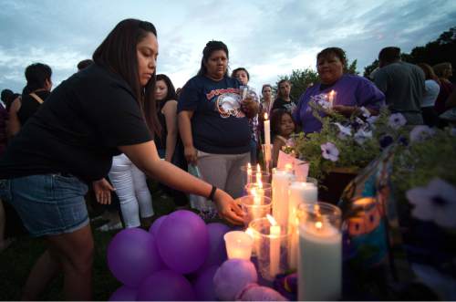 Rick Egan  |  The Salt Lake Tribune

Chanda Charley lays a candle in remembrance of Kailey Vijil, as friends and family gathered for a candle light vigil, in memory of the 12-year-old West Valley City girl who died earlier this week, Sunday, July 19, 2015.