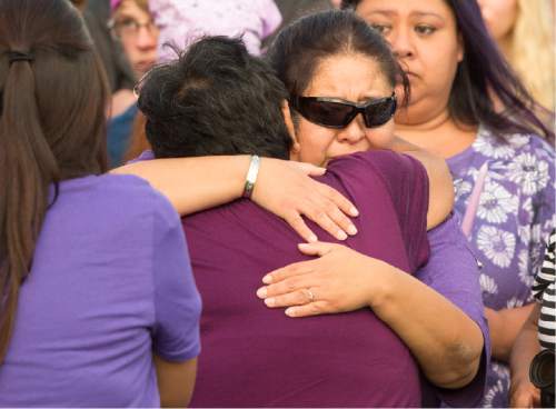 Rick Egan  |  The Salt Lake Tribune

Deshawn Vijil, mother of Kailey Vijil is comforted by a loved one, as friends and family of Kailey Vijil gather for a candle light vigil, in memory of the 12-year-old West Valley City girl who died earlier this week, Sunday, July 19, 2015.