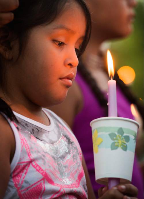 Rick Egan  |  The Salt Lake Tribune

Bobbi Smith,7, holds a candle, as friends and family of Kailey Vijil gathered for a candle light vigil, in memory of the 12-year-old West Valley City girl who died earlier this week, Sunday, July 19, 2015.