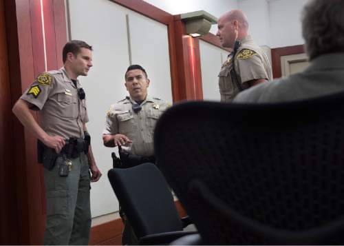 Scott Sommerdorf   |  The Salt Lake Tribune
Bailiffs discuss the way the defendant will be brought into Third District Juvenile Court Judge James Michie's courtroom, Wednesday, July 22, 2015. The 15-year-old boy accused of killing Kailey Vijil in a West Valley City field was in juvenile court at the Matheson Courthouse.