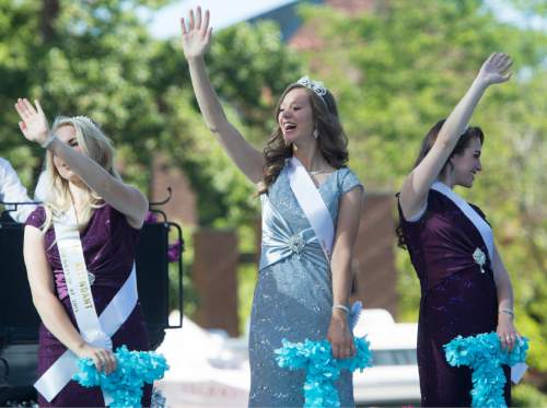 Rick Egan  |  The Salt Lake Tribune

The Days of 47 Royalty, 
From left, Christina Muhlestein, first attendant: Madeline Field, queen; and Kaitlin Paxton, second attendant, in Days of '47 parade, Friday, July 24, 2015.
