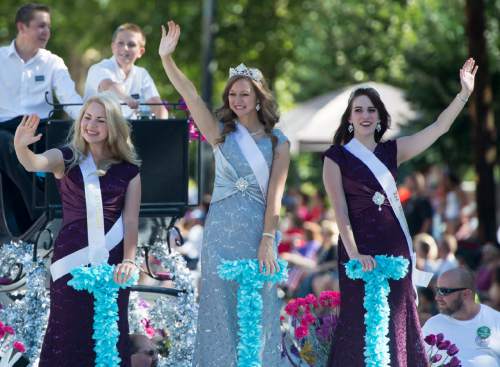 Rick Egan  |  The Salt Lake Tribune

The Days of 47 Royalty, 
From left, Christina Muhlestein, first attendant: Madeline Field, queen; and Kaitlin Paxton, second attendant, in Days of '47 parade, Friday, July 24, 2015.