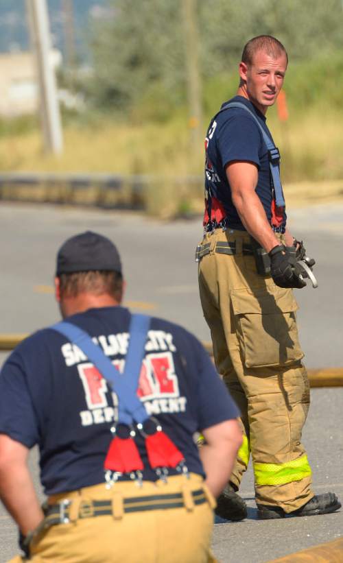 Leah Hogsten  |  The Salt Lake Tribune
A fire, reported about 3:45 p.m. Sunday, July 25, 2015, started at 879 S. Gladiola St., near a 78,000-square-foot, one-story building used by a furniture company was quickly put out. Captain Mark Bednarik with the Salt Lake City Fire Department said semi-trailers and pallets first caught fire, before the blaze began to spread to the building itself as firefighters arrived. No employees were there at the time the fire began, Bednarik said, and there are no injuries.