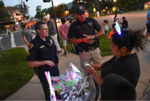 Francisco Kjolseth | The Salt Lake Tribune
Sgt. Lisa Pascadlo and Det. Mason Givens check in with a vendor without a permit as they patrol the parade route the night before the Pioneer Day parade on Thursday night, July, 23, 2015.