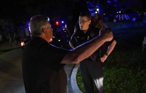 Francisco Kjolseth | The Salt Lake Tribune
Sgt. Lisa Pascadlo listens to a man give an account about being involved in an altercation with bicyclists  wearing dark clothing and no lights along the Pioneer Day parade route on Thursday night, July 23, 2015.