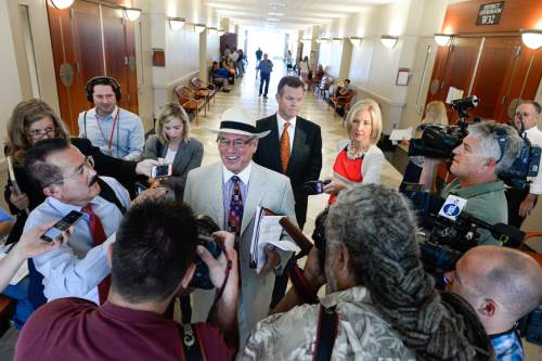 Francisco Kjolseth | The Salt Lake Tribune
Former Utah Attorney General John Swallow, center right,  exits the courtroom into awaiting media at the Matheson Courthouse in Salt Lake City on Monday, July, 27, 2015, behind his attorney Steve McCaughey. Swallow who appeared for an arraignment hearing had his attorney plead not guilty on his behalf to more than a dozen criminal charges of corruption.