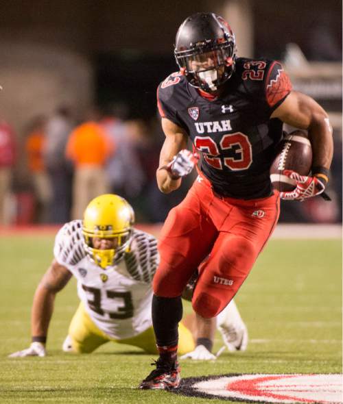 Rick Egan  |  The Salt Lake Tribune

Oregon Ducks linebacker Tyson Coleman (33) watches as Ute running back Devontae Booker (23) runs the ball into the end zone for a touchdown, in Pac-12 football action, Utah vs. Oregon game, at Rice-Eccles Stadium, Saturday, November 8, 2014