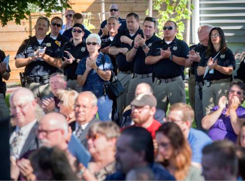 Steve Griffin  |  The Salt Lake Tribune


Community members join SLPD officers during dedication program for the Ron Heaps Memorial Park in Salt Lake City, Thursday, July 30, 2015.  Heaps, a Salt Lake City police officer  was shot and killed while investigating a suspicious person complaint in Salt Lake City in 1982.