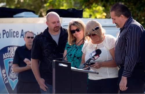 Steve Griffin  |  The Salt Lake Tribune


Heaps family members receive an award during dedication program for the Ron Heaps Memorial Park in Salt Lake City, Thursday, July 30, 2015.  Heaps, a Salt Lake City police officer  was shot and killed while investigating a suspicious person complaint in Salt Lake City in 1982.