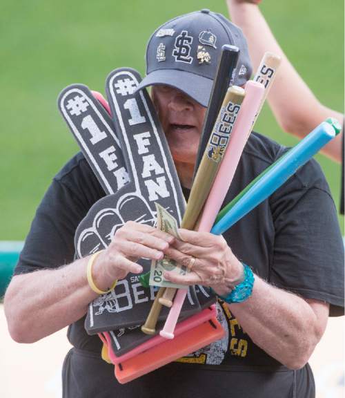 Rick Egan  |  The Salt Lake Tribune

Paul Watson sells souvenir bats, baseballs, and foam fingers, at the Salt Lake Bees game, Monday, May 25, 2015. Watson has selling programs, souvenirs, and peanuts at sporting events for 27 years.
