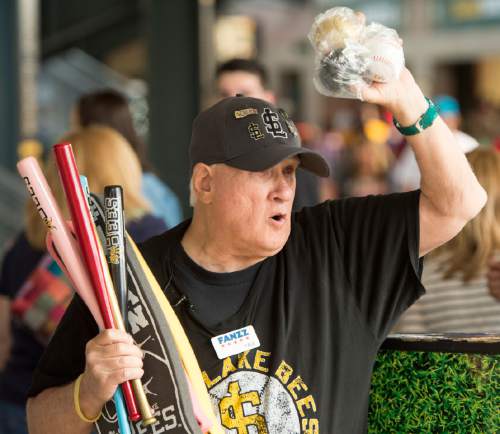Rick Egan  |  The Salt Lake Tribune

Paul Watson sells souvenir bats, baseballs, and foam fingers, at the Salt Lake Bees game, Monday, May 25, 2015. Watson has selling programs, souvenirs, and peanuts at sporting events for 27 years.